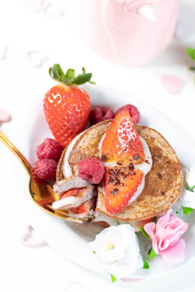 vanilla raspberry pancakes topped with fresh strawberries