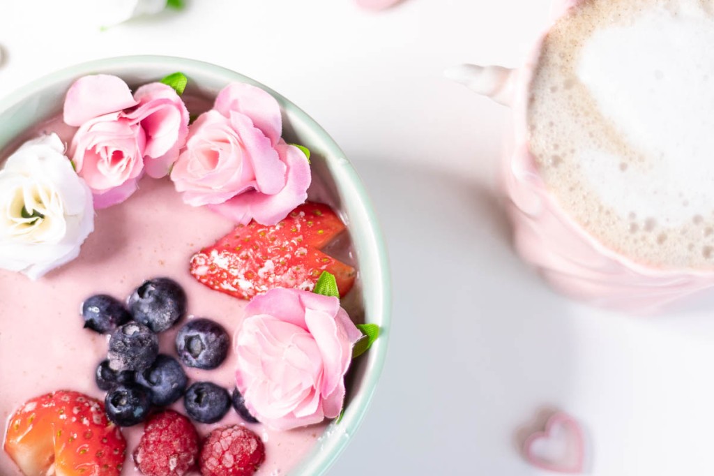 vegan pink smoothie bowl with a cup of coffee